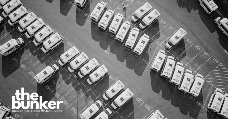 Fleet of commercial vans parked in a row, representing vehicles equipped with GPS tracking for improved safety and operational efficiency